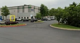 Warehouse parking lot with a yellow box highlighting the building entrance