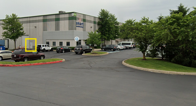 Warehouse parking lot with a yellow box highlighting the building entrance